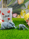 A pair of elephant resin garden ornaments