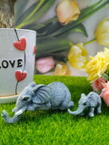 A pair of elephant resin garden ornaments