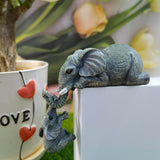 A pair of elephant resin garden ornaments