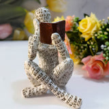 Contemplative reader male resin ornament