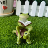 The frog sitting on the turtle reading a book